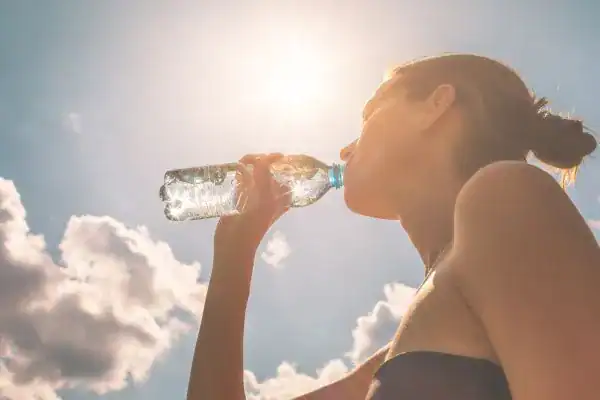 Hydration: The Secret Ingredient for a Toned Stomach and Enhanced Fitness 3 Image of woman drinking water to hydrate Chesterfield after run.